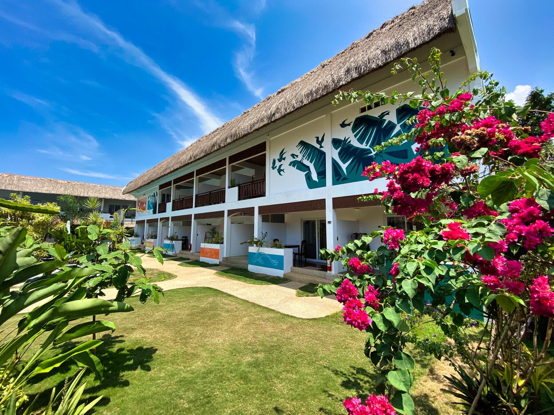 Resort building with bougainvillea and tropical garden